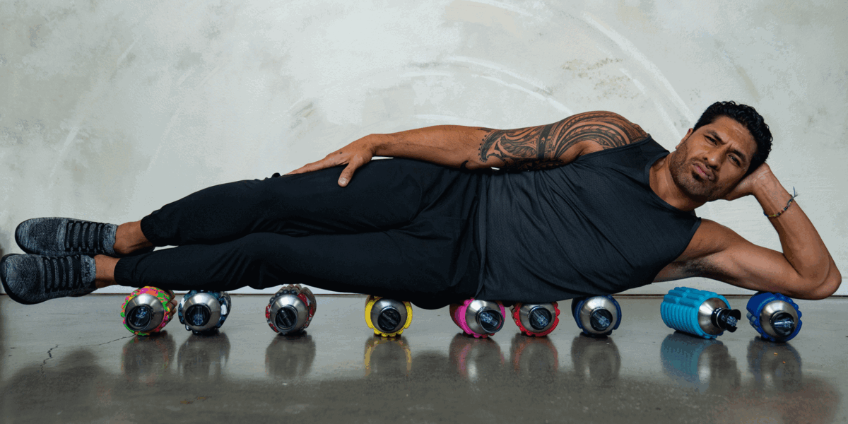 a man lying on 9 colorful Mobot Foam Roller Water Bottles