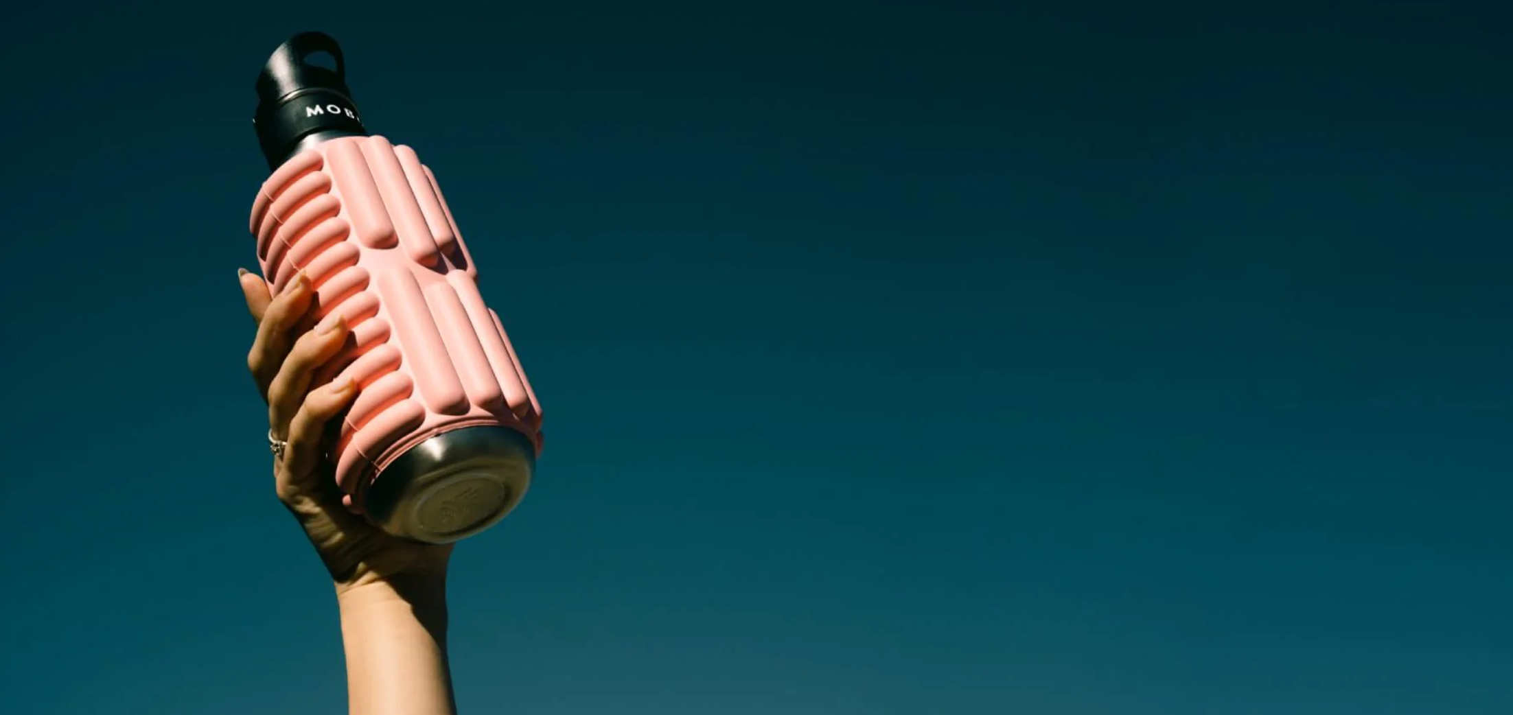 pink foam roller water bottle hold in a hand mobot