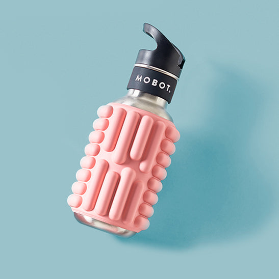 pink Motbot flatlay foam roller water bottle on a blue background