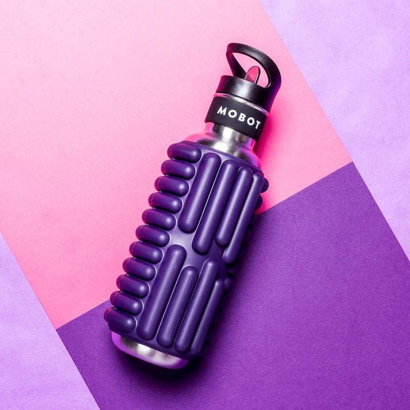 purple Motbot Grace foam roller water bottle on a colorful background