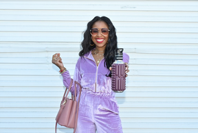 a woman dressed in purple holdig a purple grace Mobot 27oz foam roller water bottle 